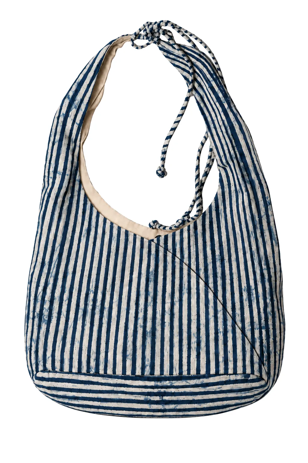 Front view of an indigo and ivory striped batik hobo shoulder bag on a pure white background