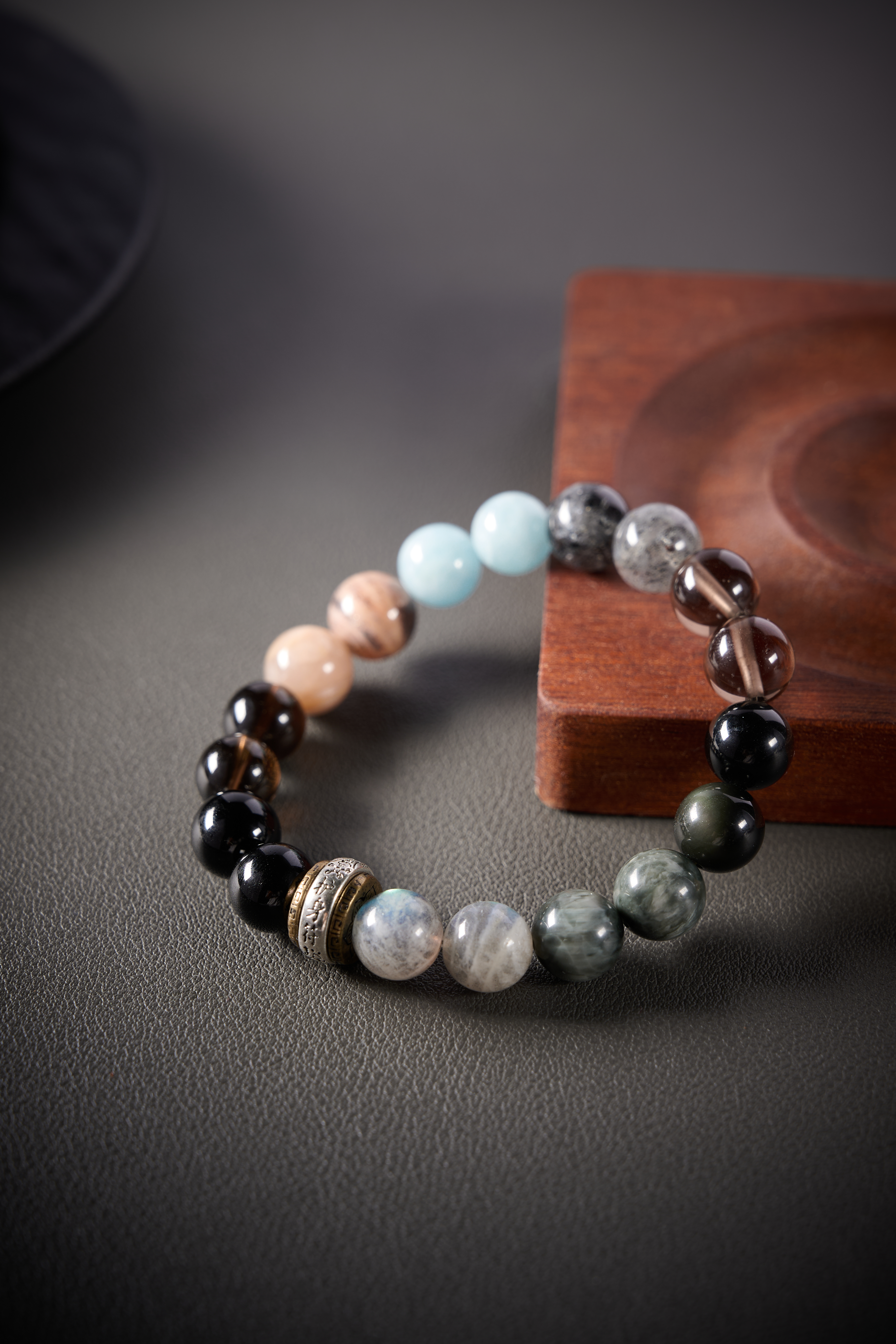 Detail – aquamarine’s soft blue tone beside neutral stones, translucent and calming look.