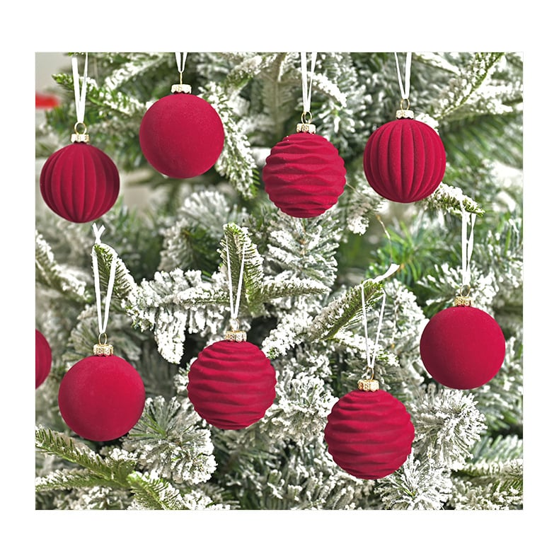 Assorted red ornaments on a flocked Christmas tree