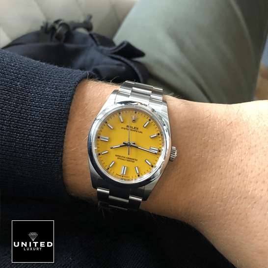 Rolex Perpetual 124300 Yellow Dial Stick indices Replica on his arm