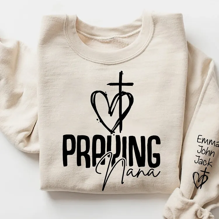 Custom Praying Nana Sweatshirt with Grandkids Names on Sleeve, Hand Drawn Cross Heart Faith Based Pullover
