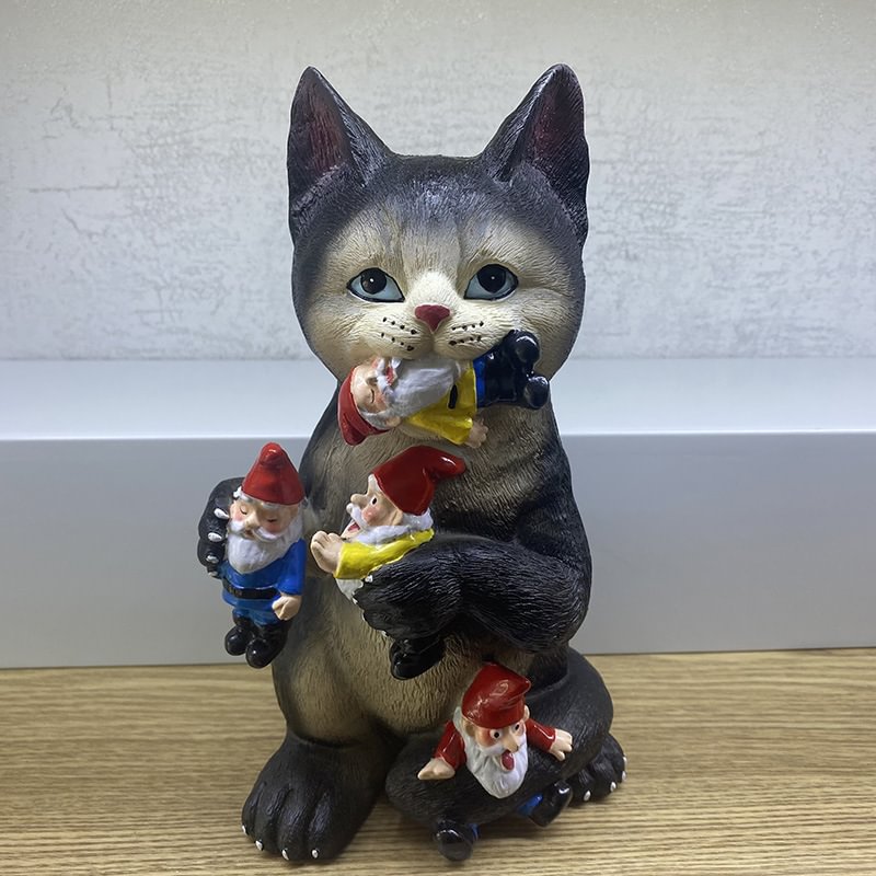 cat eating gnomes figurine