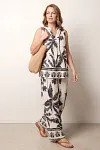 Front view of women's palm tree print two-piece set featuring sleeveless V-neck top and wide-leg trousers