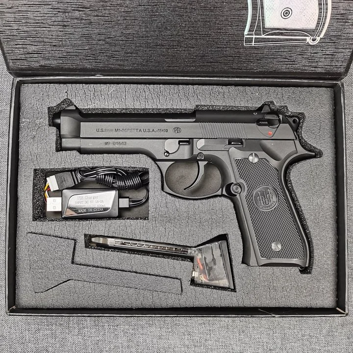 Action shot of Beretta M92F gel blaster, simulating real firearm shooting