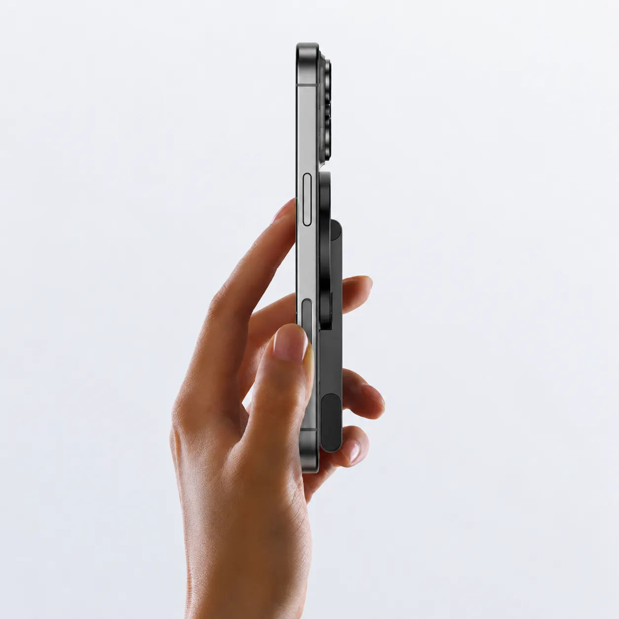 Side view of the slim folded magnetic stand stored on the phone back
