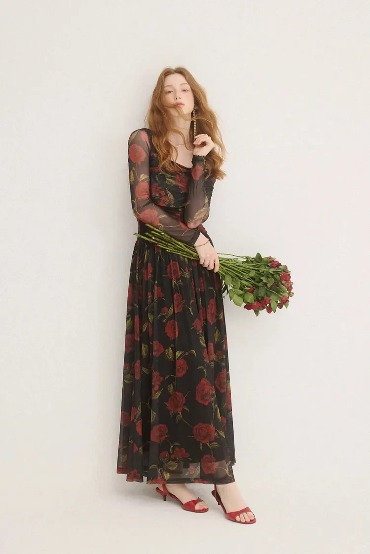 An elegant black maxi dress with a red floral pattern.