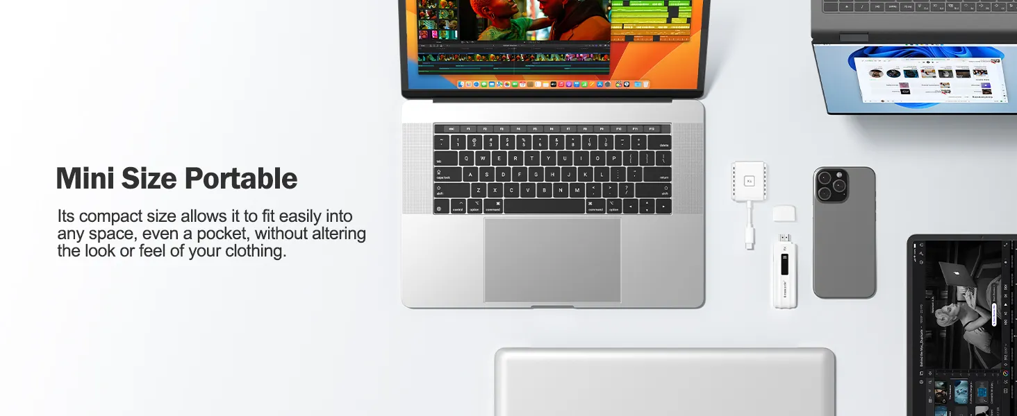 Laptop workspace setup with portable monitor, keyboard, smartphone, and accessories arranged on white surface, highlighting mobile workstation capabilities.
