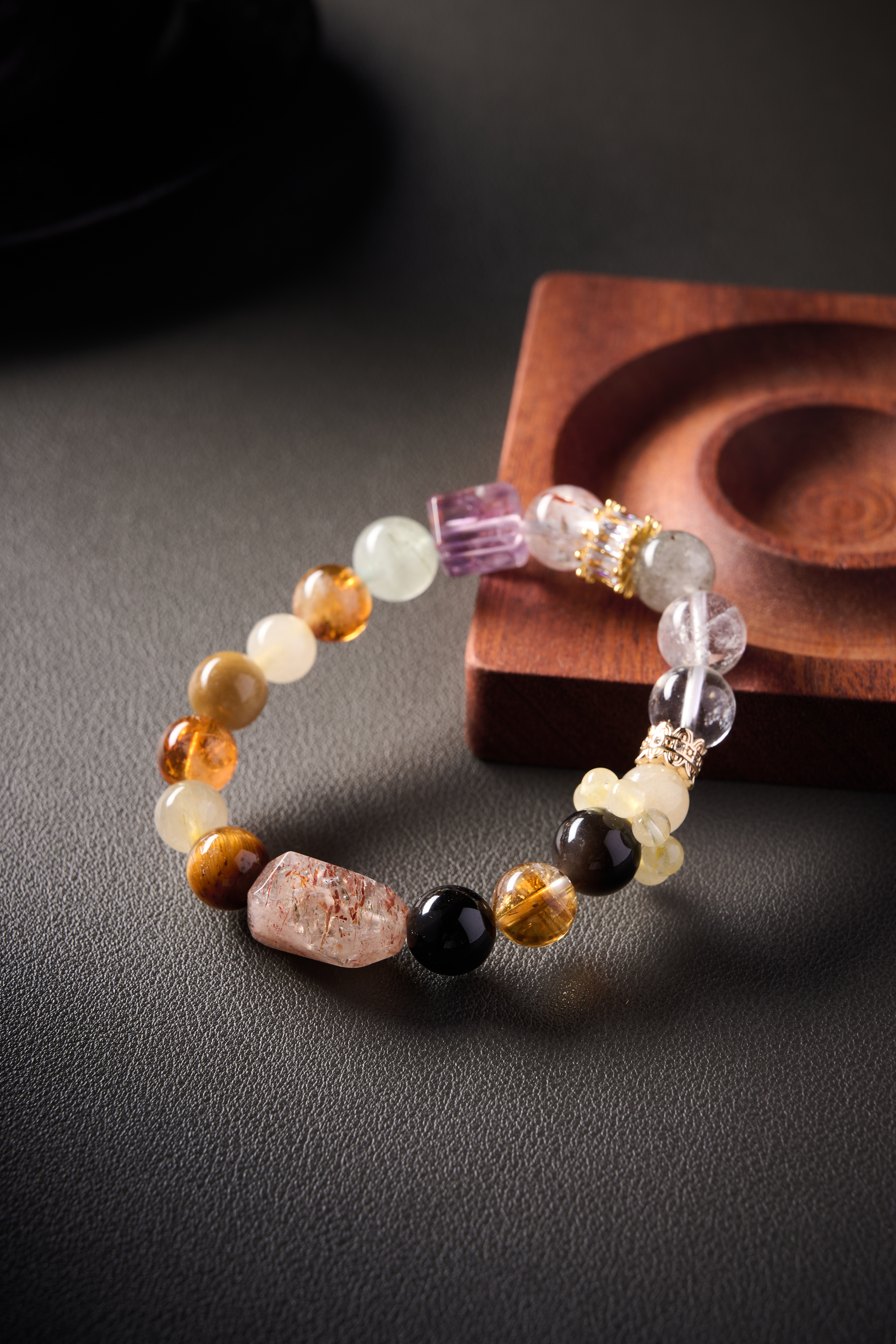 Color mix close-up – yellow jade’s warm tone blending with citrine and clear quartz, smooth polish.