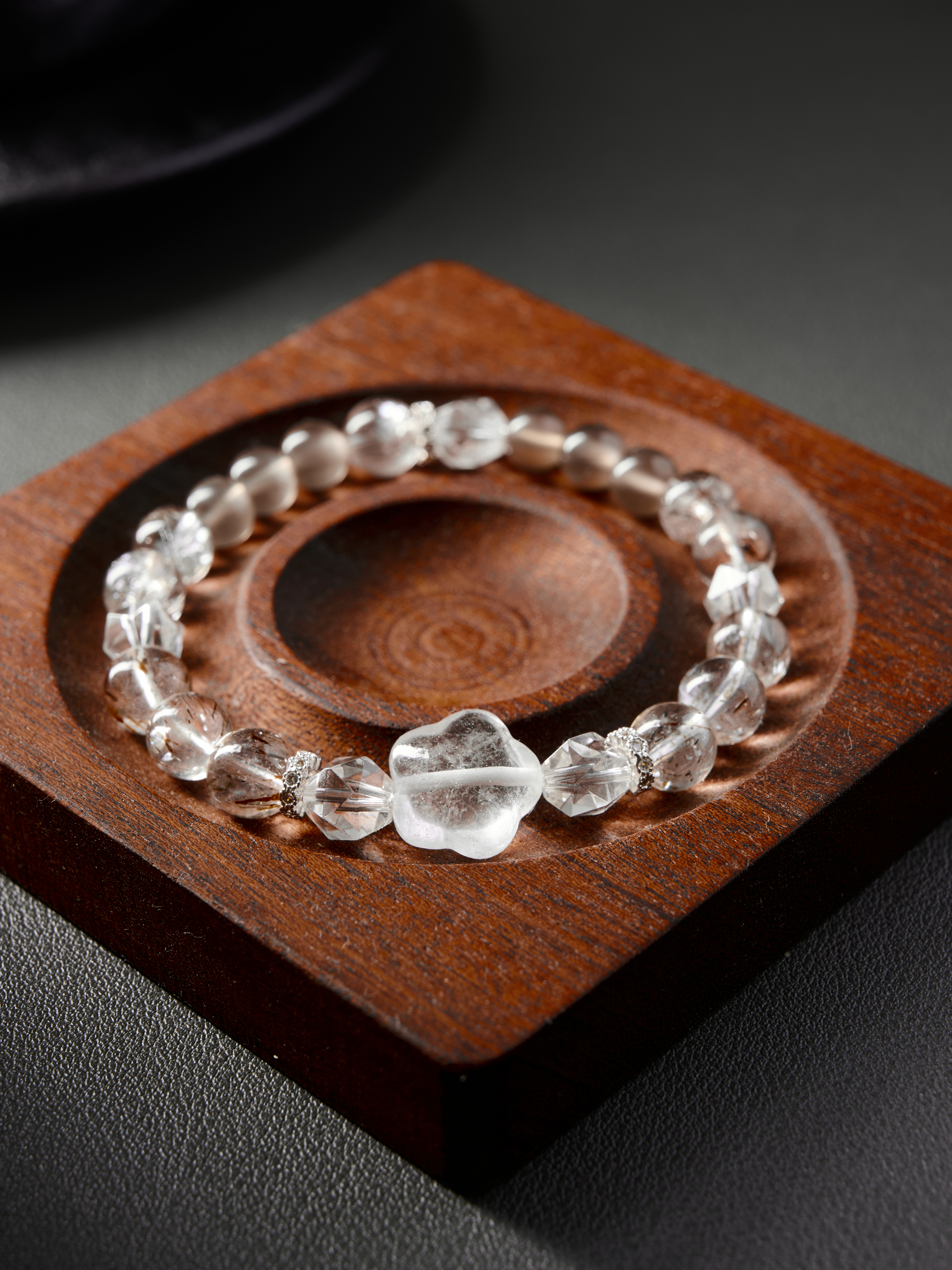 Diagonal flat composition highlighting faceted clear quartz and soft blush rose quartz, hand-strung