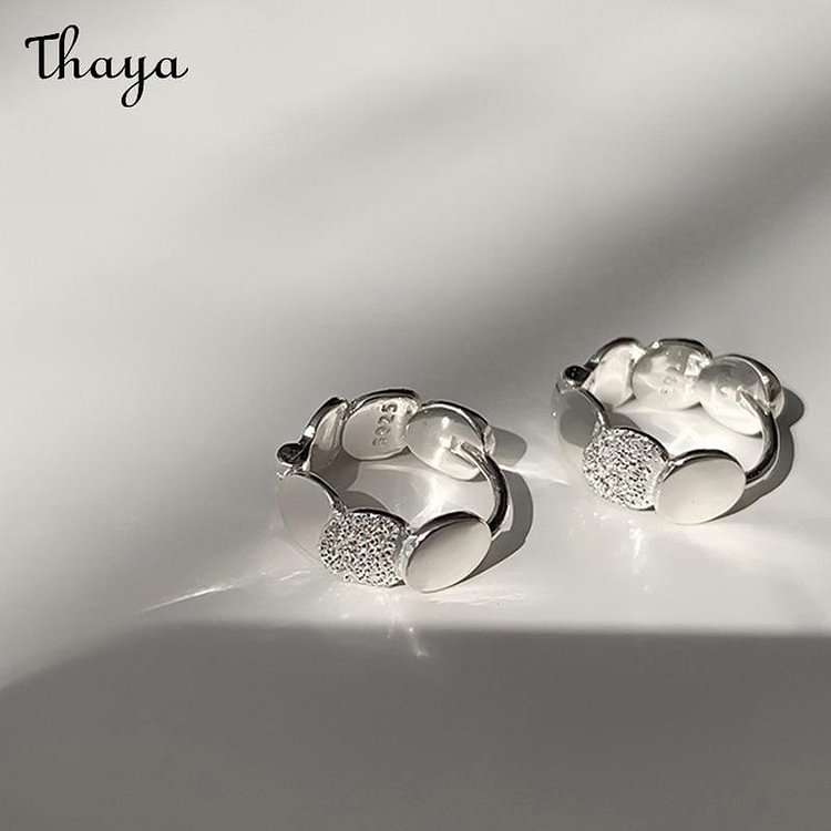 Thaya Frosted Disc Ear Buckles