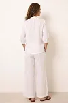 Back view of women's white linen set showing relaxed fit and clean silhouette