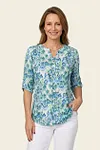 Front view of vibrant blue and green ikat print henley blouse for women