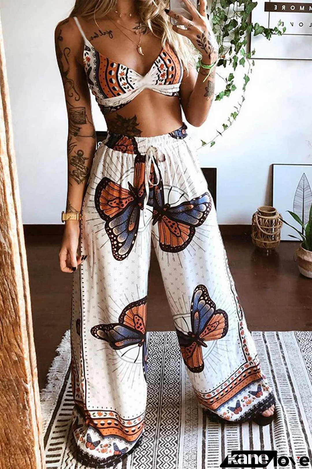 Top with butterfly print and wide leg trousers