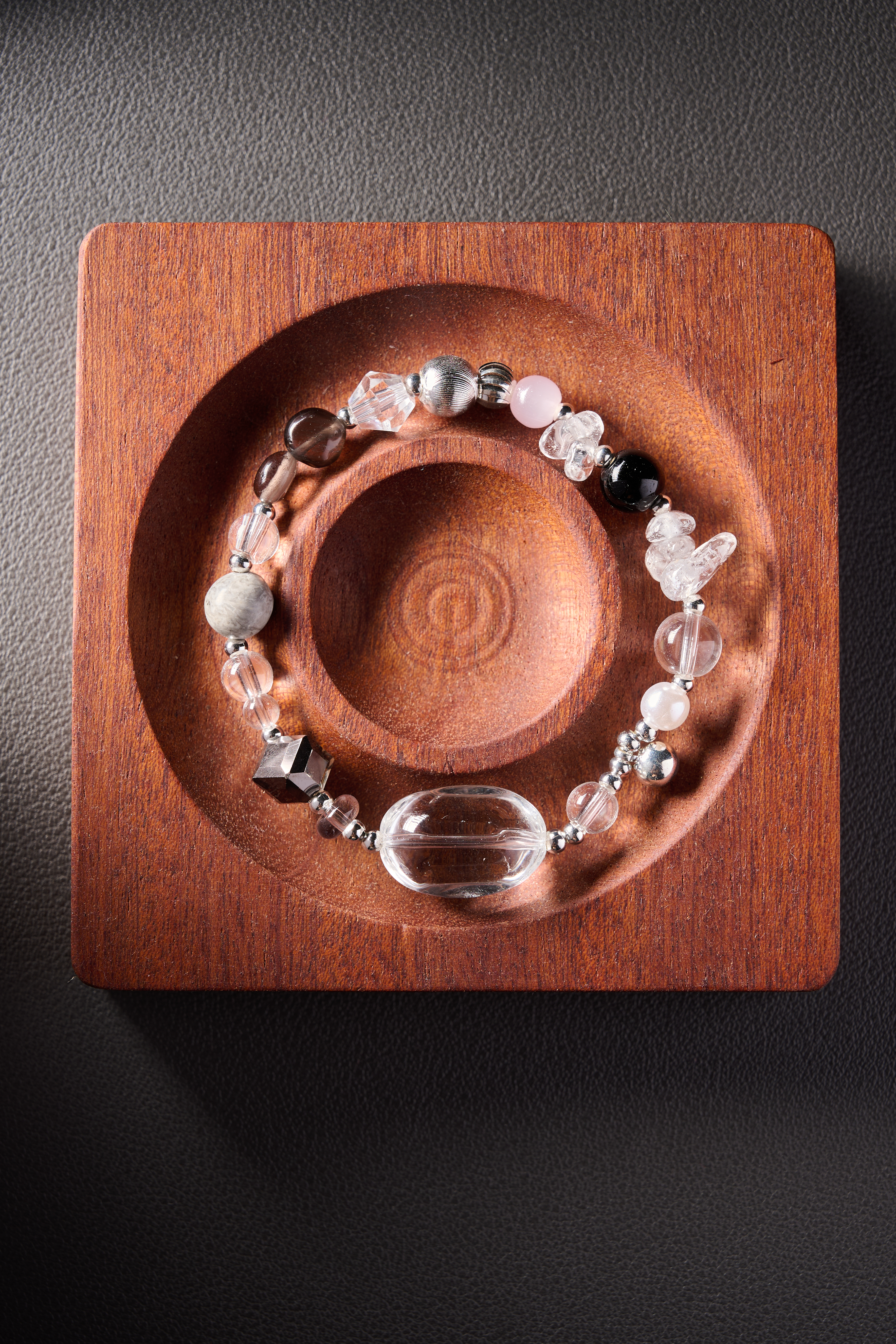 Macro focus – bracelet curve showing handmade elastic cord design.