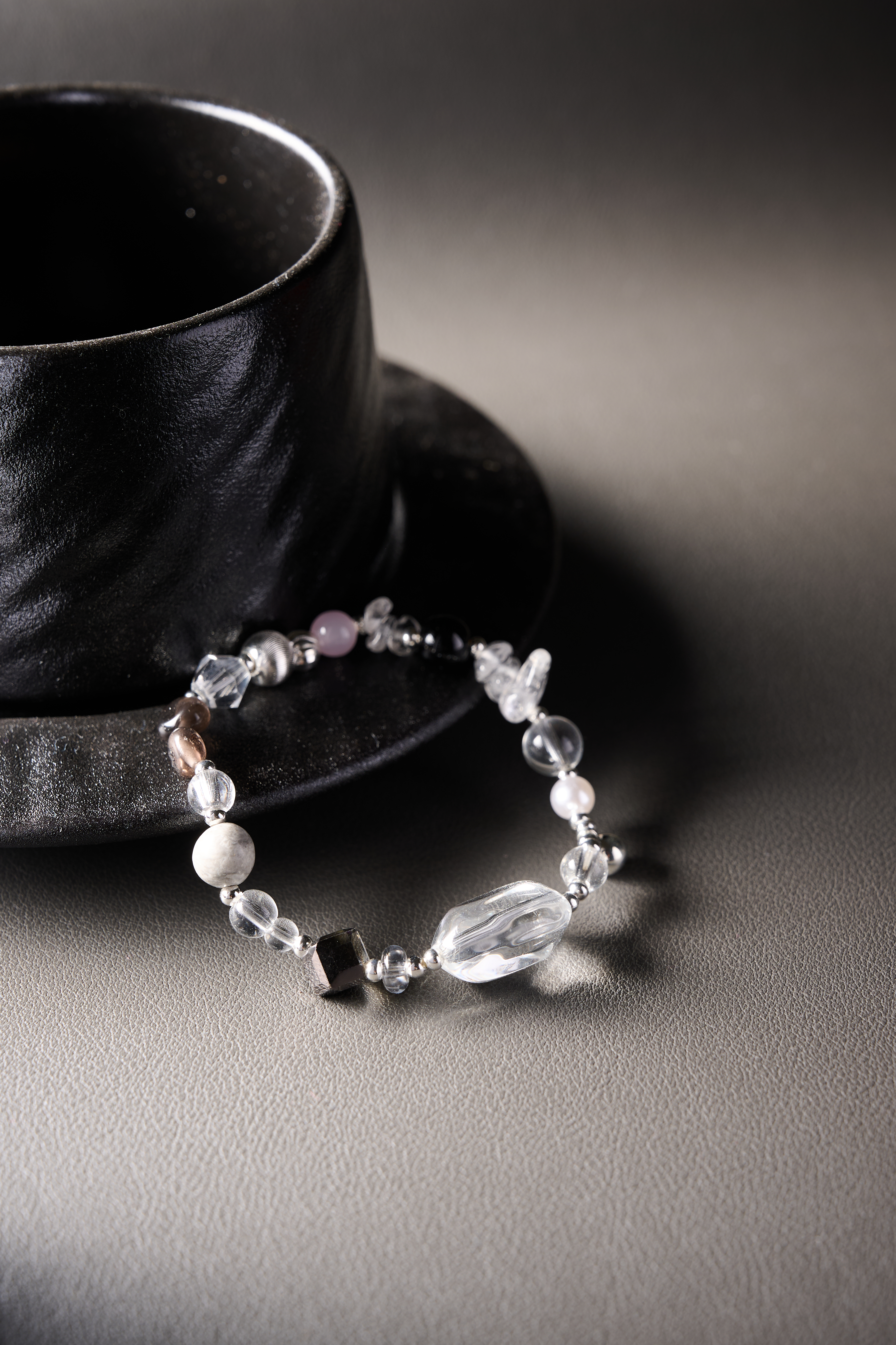 Angle view – smoky quartz beads blending with clear crystals.