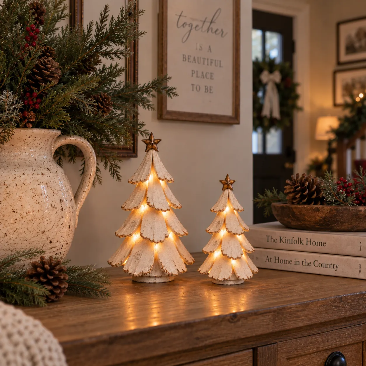 Vintage lighted Christmas tree figurines glowing on a warm farmhouse console