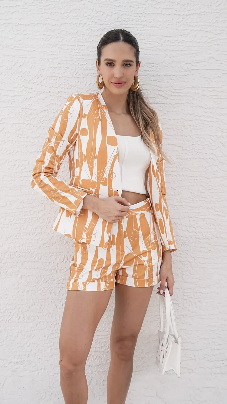 abstract print adorning a vibrant yellow blazer