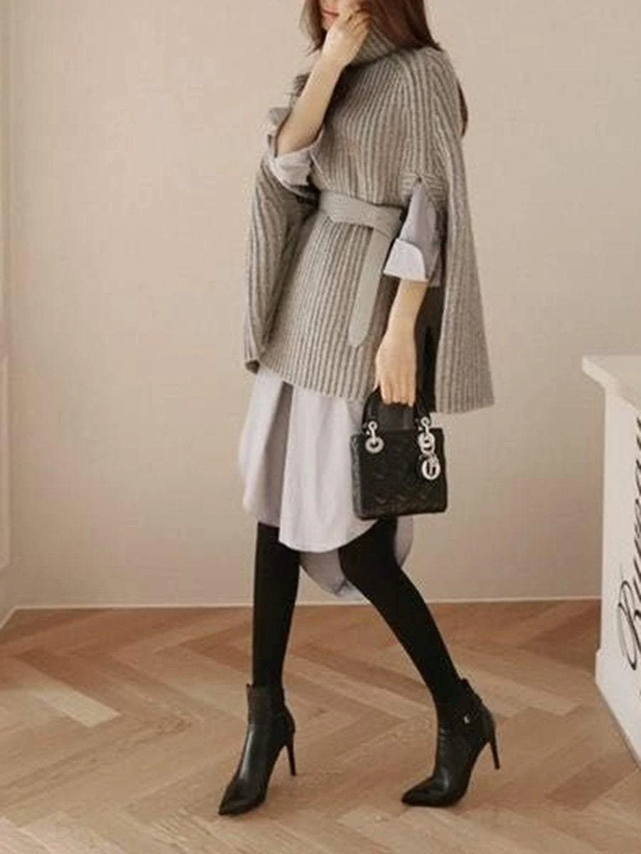 A pullover with a high collar that goes with a poncho knit sweater with split ends