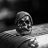 Bearded tough guy wearing hat skull rings for men