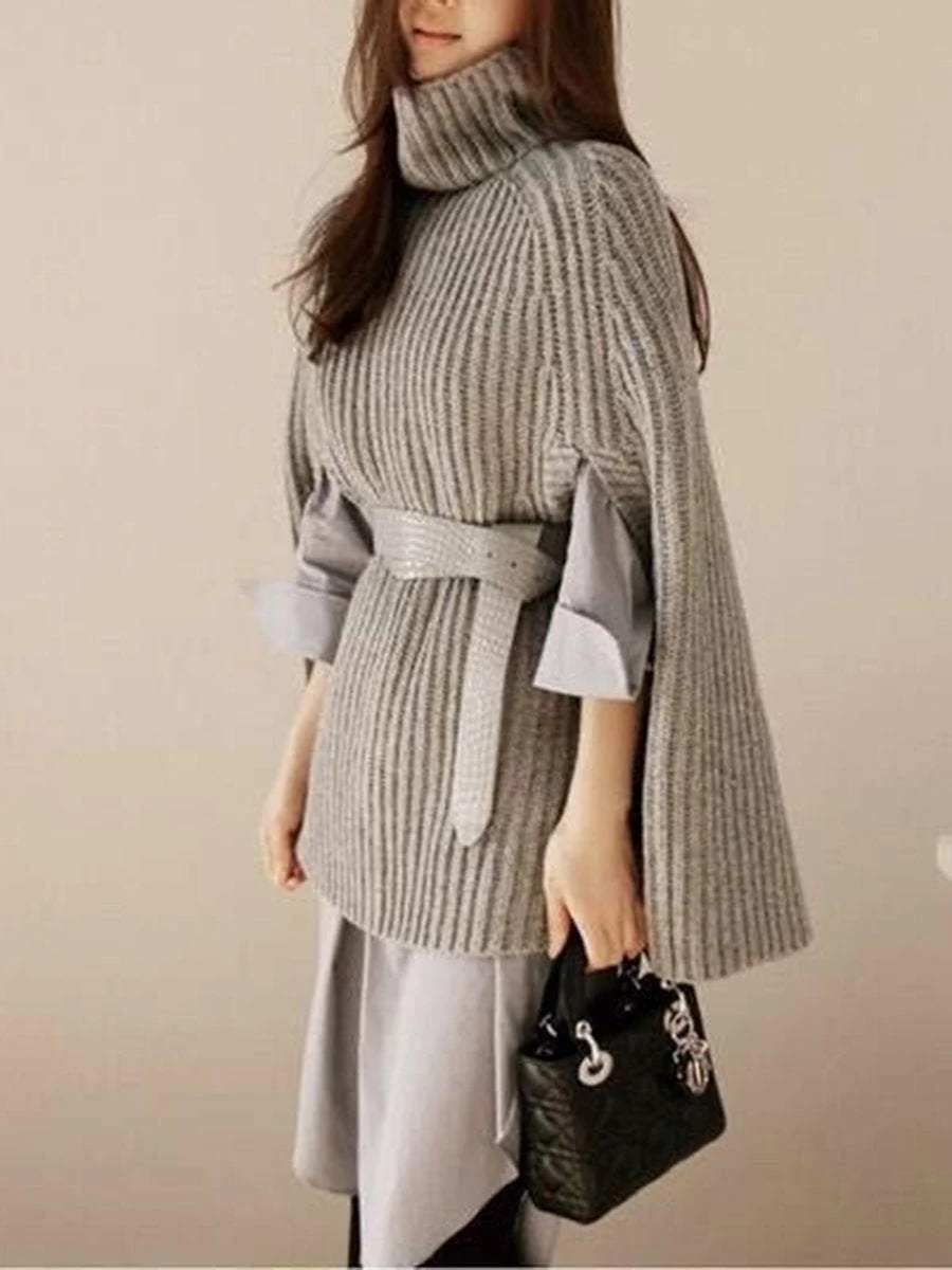 A pullover with a high collar that goes with a poncho knit sweater with split ends