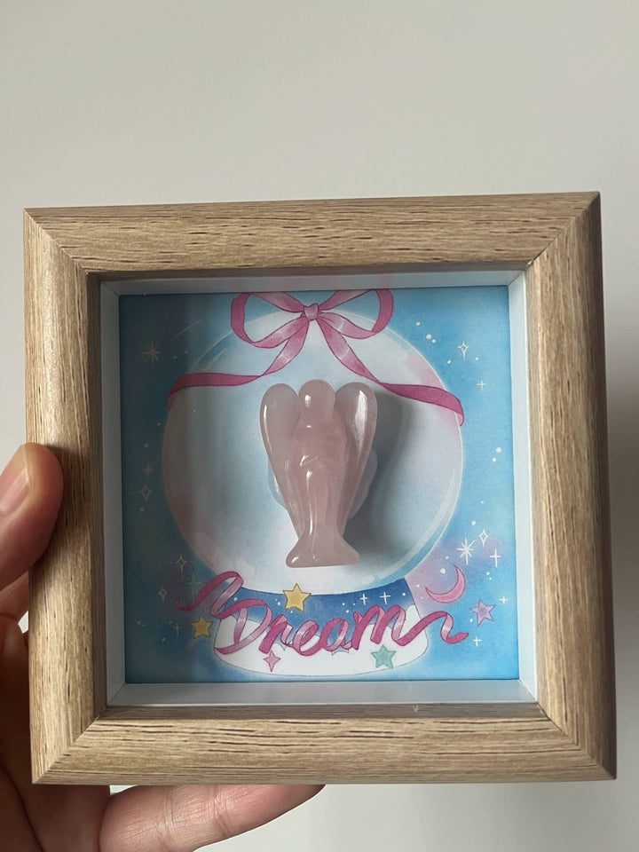 Crystal guardian angel in wooden frame close-up