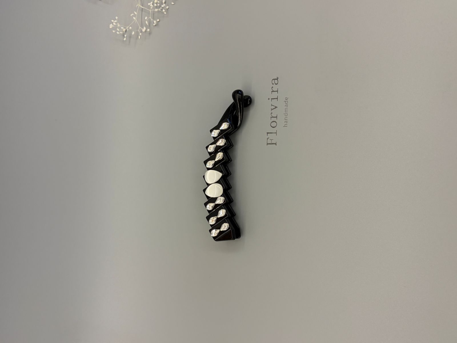 Black PC stepped banana hair clip with multi-faceted teardrop glass rhinestones and teardrop resin cat's eye decor