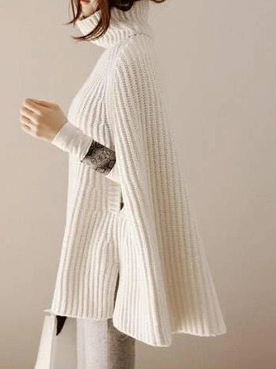 A pullover with a high collar that goes with a poncho knit sweater with split ends