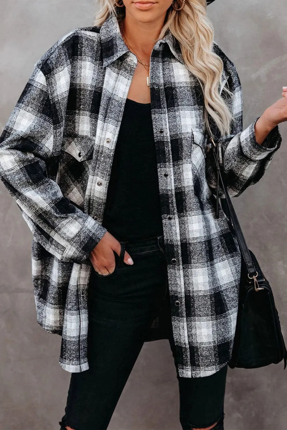 Woman in an oversized flannel shirt layered over a thermal