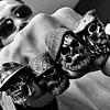 Bearded tough guy wearing hat skull rings for men