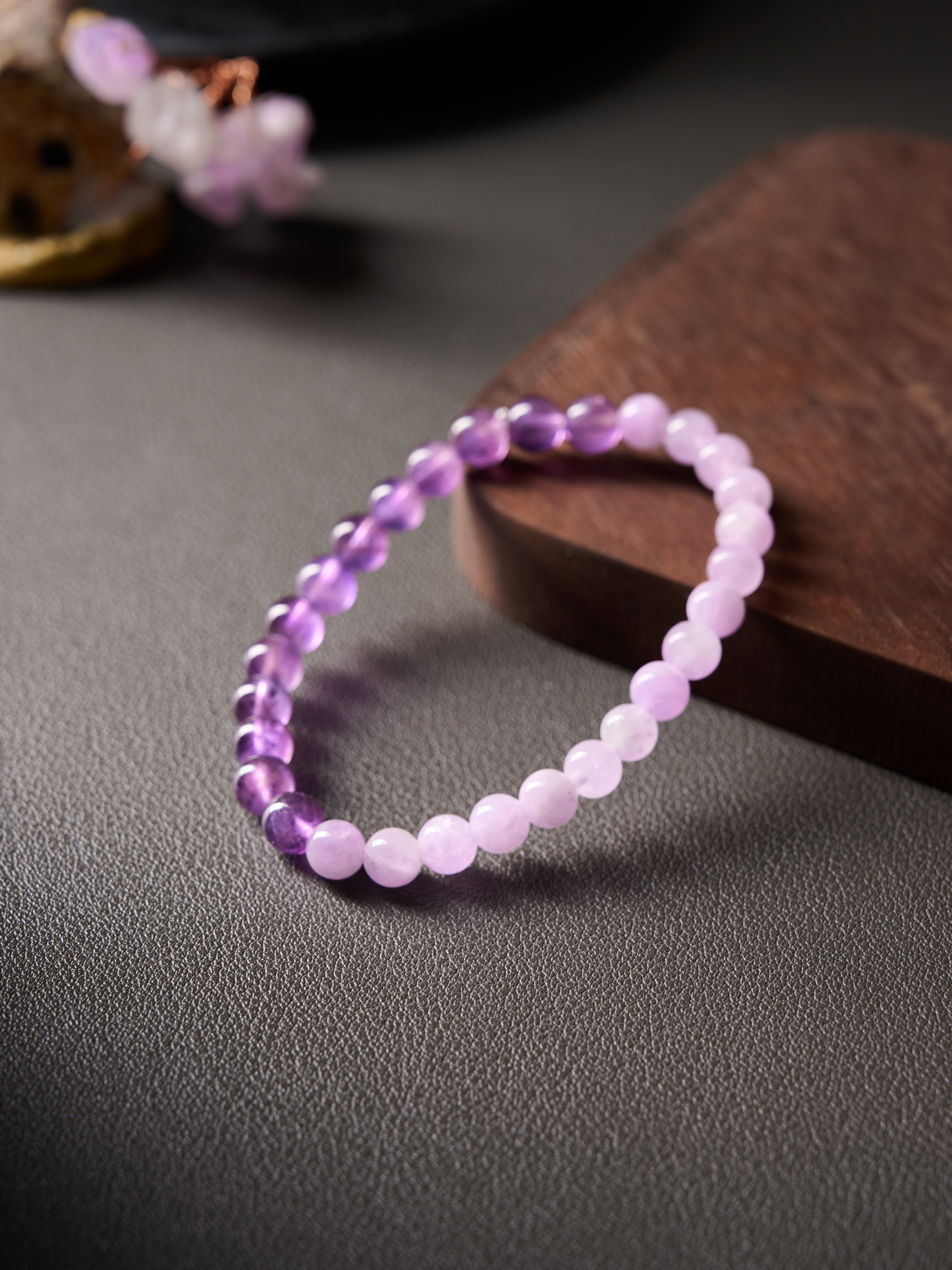 Angled side shot highlighting spacing and natural color variation in amethyst and kunzite beads