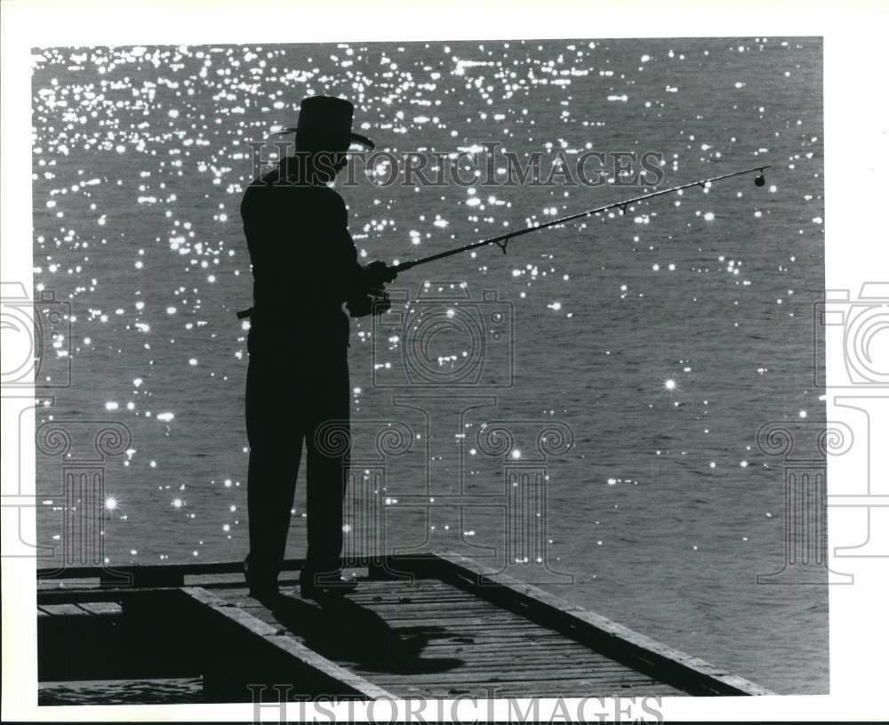 Press Photo Poster painting Dave Garza test fishing pole in Woodlawn Lake - sax28168