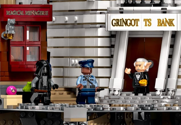 3 LEGO Harry Potter minifigure characters standing in front of Gringotts Bank