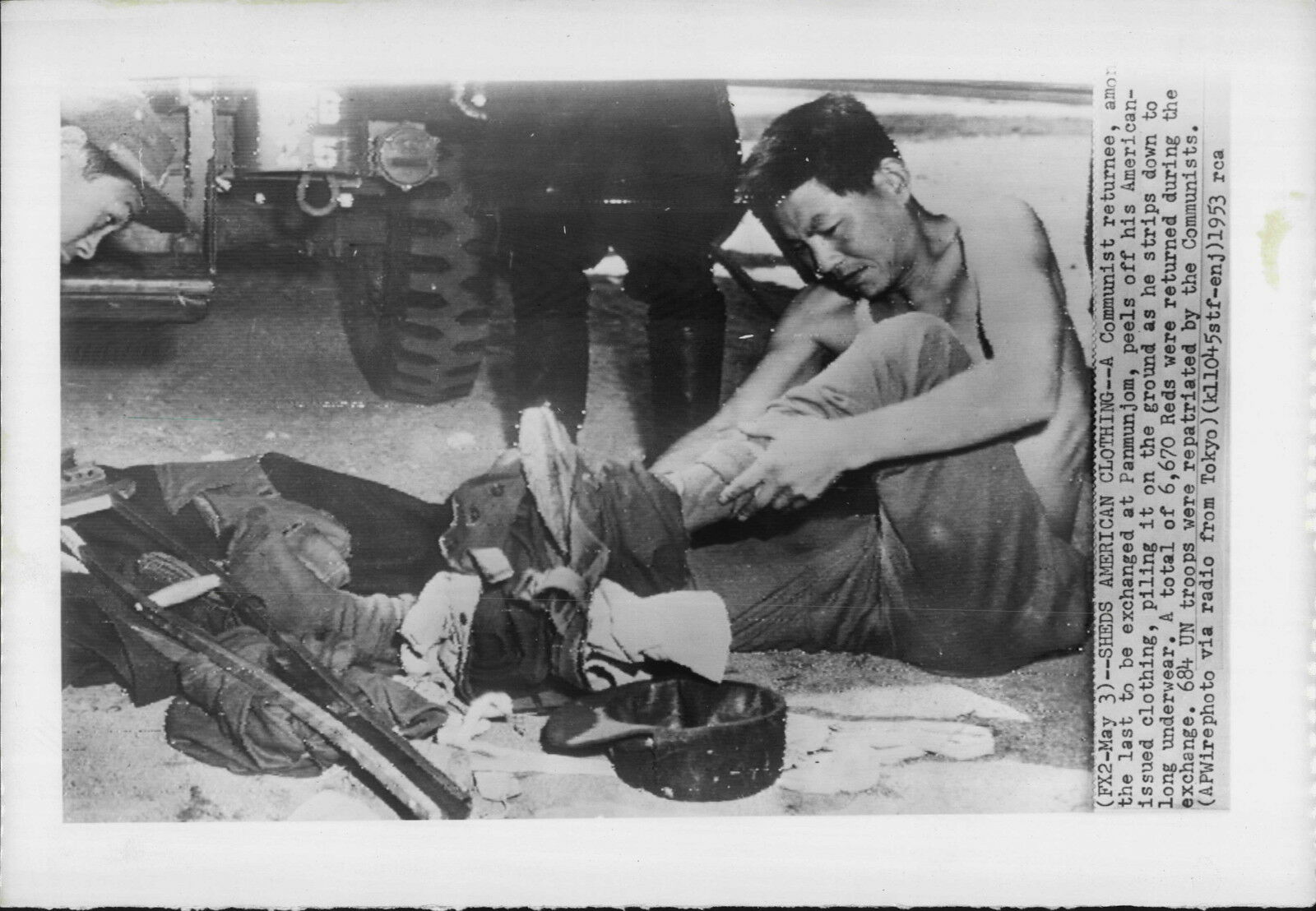 d Prisoner Sheds Allied Clothing at Panmunjom 1953 Korea War Press Photo Poster painting