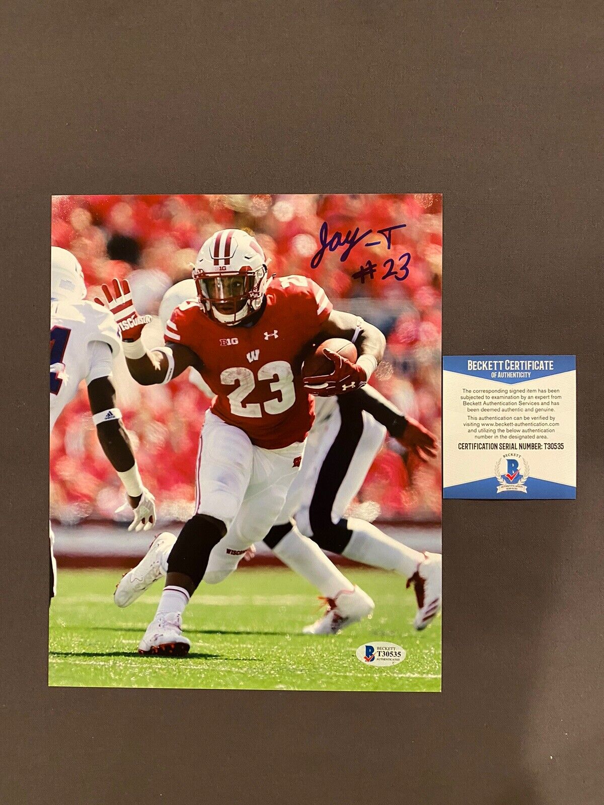 BECKETT COA! JONATHAN TAYLOR Signed Autographed WISCONSIN Football 8x10 Photo Poster painting