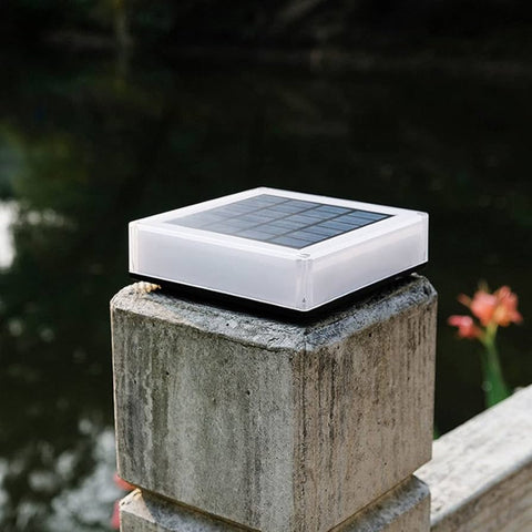 Solar-powered LED post cap light with a sleek square design, featuring a frosted casing and a top-mounted solar panel. Perfect for outdoor spaces like fences, decks, and garden pillars.