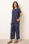 Front view of navy blue two-piece set featuring geometric line print top and wide-leg pants
