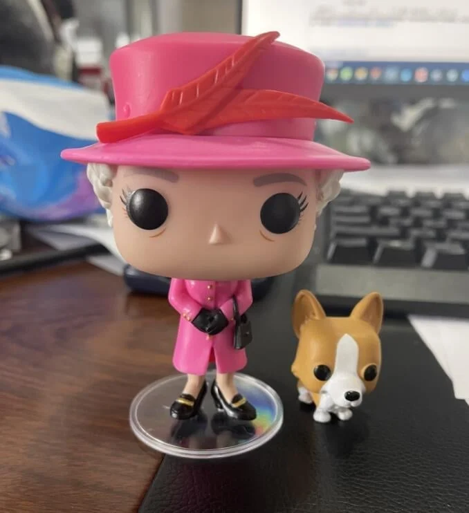 Queen of England character and corgi scale model