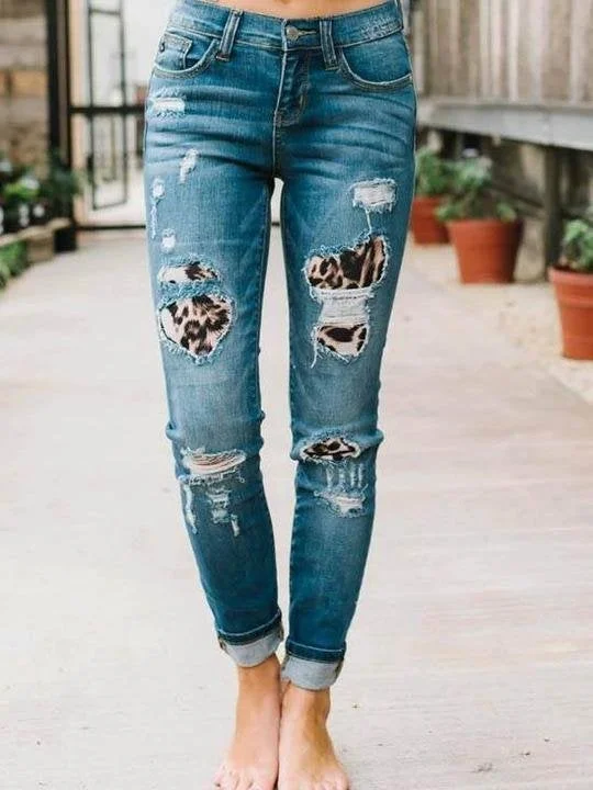 Ripped leopard print denim trousers