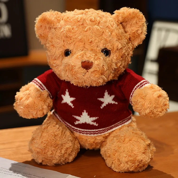 Teddy bear stuffed toy doll wearing sweater