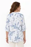 Back view of women's floral linen blouse showing back yoke and pleated detail for a relaxed fit