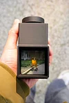 Handheld waist-level viewfinder composition trainer