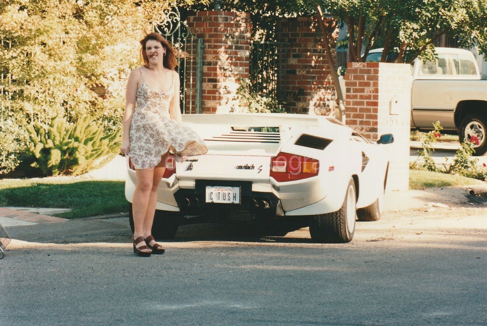 FOUND Photo Poster painting Lamborghini Girl WINDY REDHEAD Original Snapshot VINTAGE 96 26 F