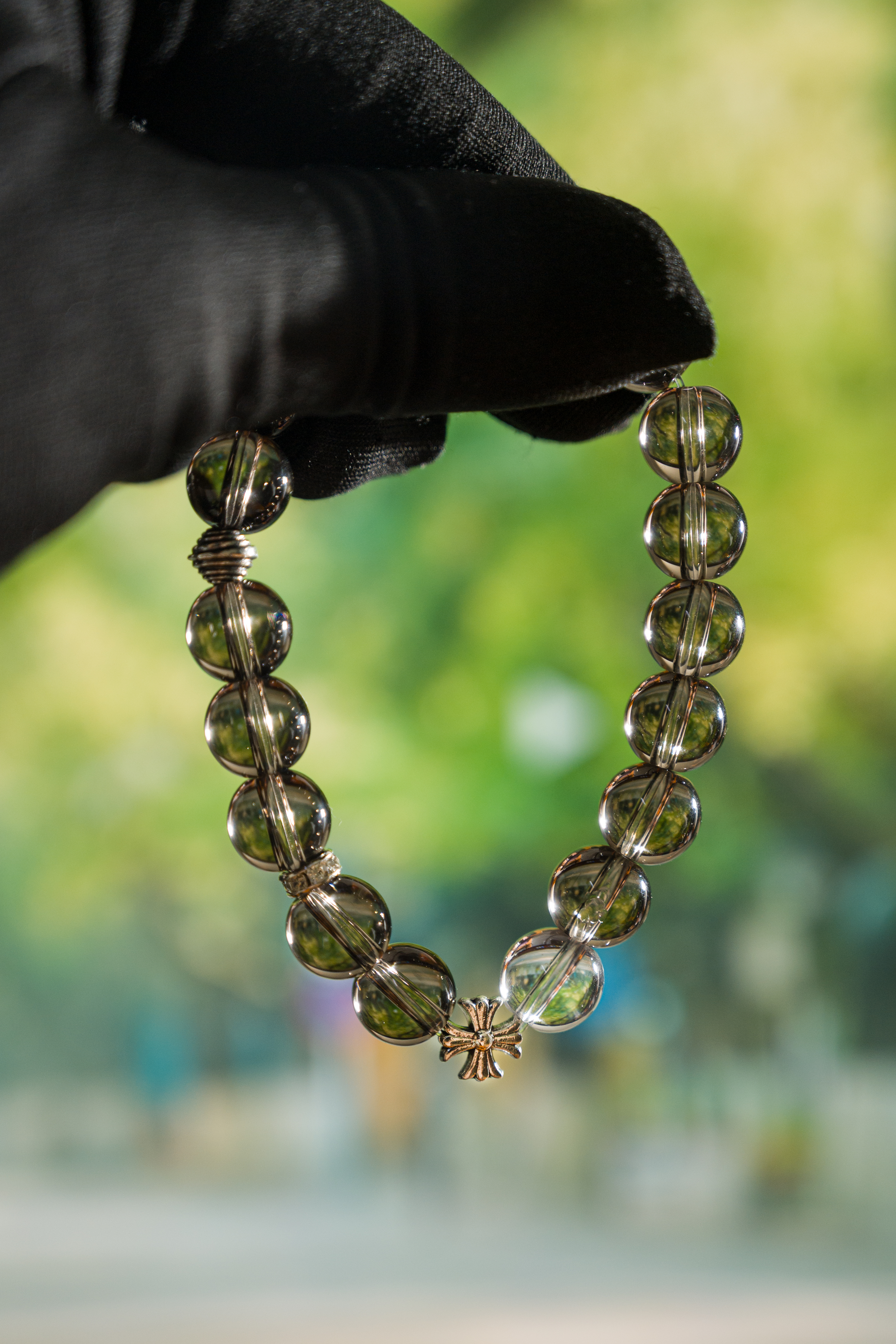 Wrist-on shot – smoky quartz protection bracelet worn on hand, everyday minimalist styling.