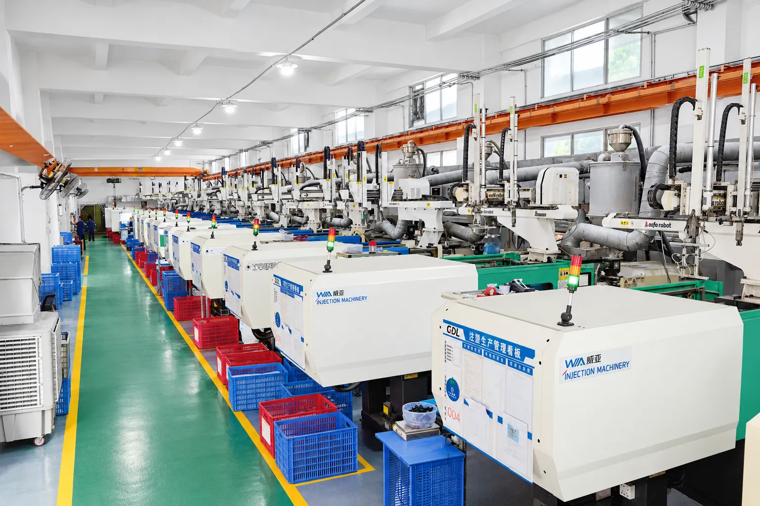 Injection molding machines and handling equipment in the GDL workshop