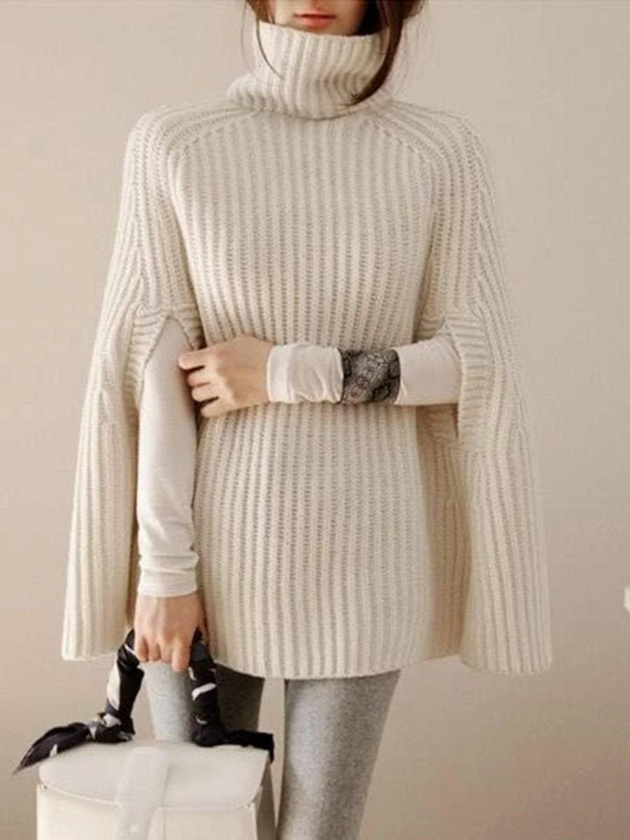 A pullover with a high collar that goes with a poncho knit sweater with split ends