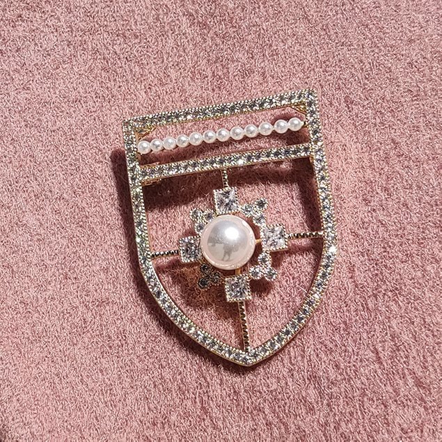 A Pearl Stitched Shield Brooch