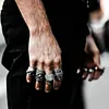 Bearded tough guy wearing hat skull rings for men