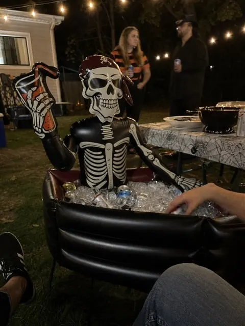 Pirate skeleton cooler at a casual nighttime backyard party