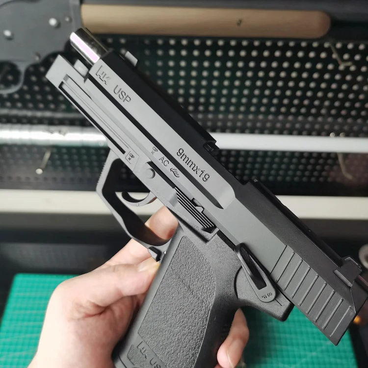 Side view of USP laser pistol showcasing ergonomic design and blowback system