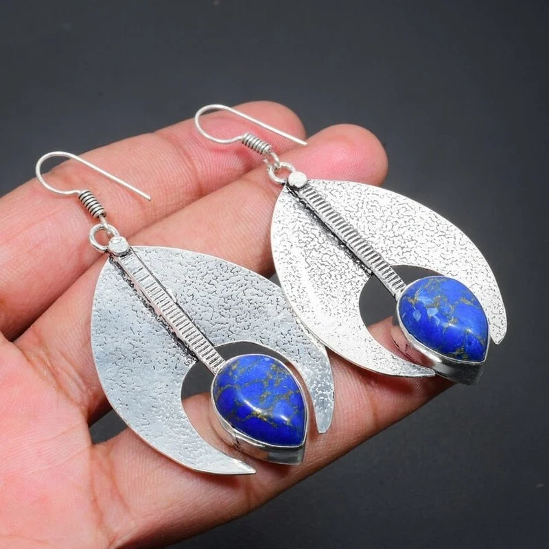 Simple horn-shaped earrings in antiqued metal with drop-shaped lapis lazuli hook drop earrings for women